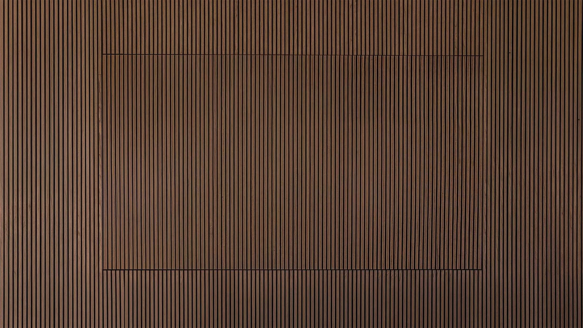 Warm vertical wood slat wall with the display at rest